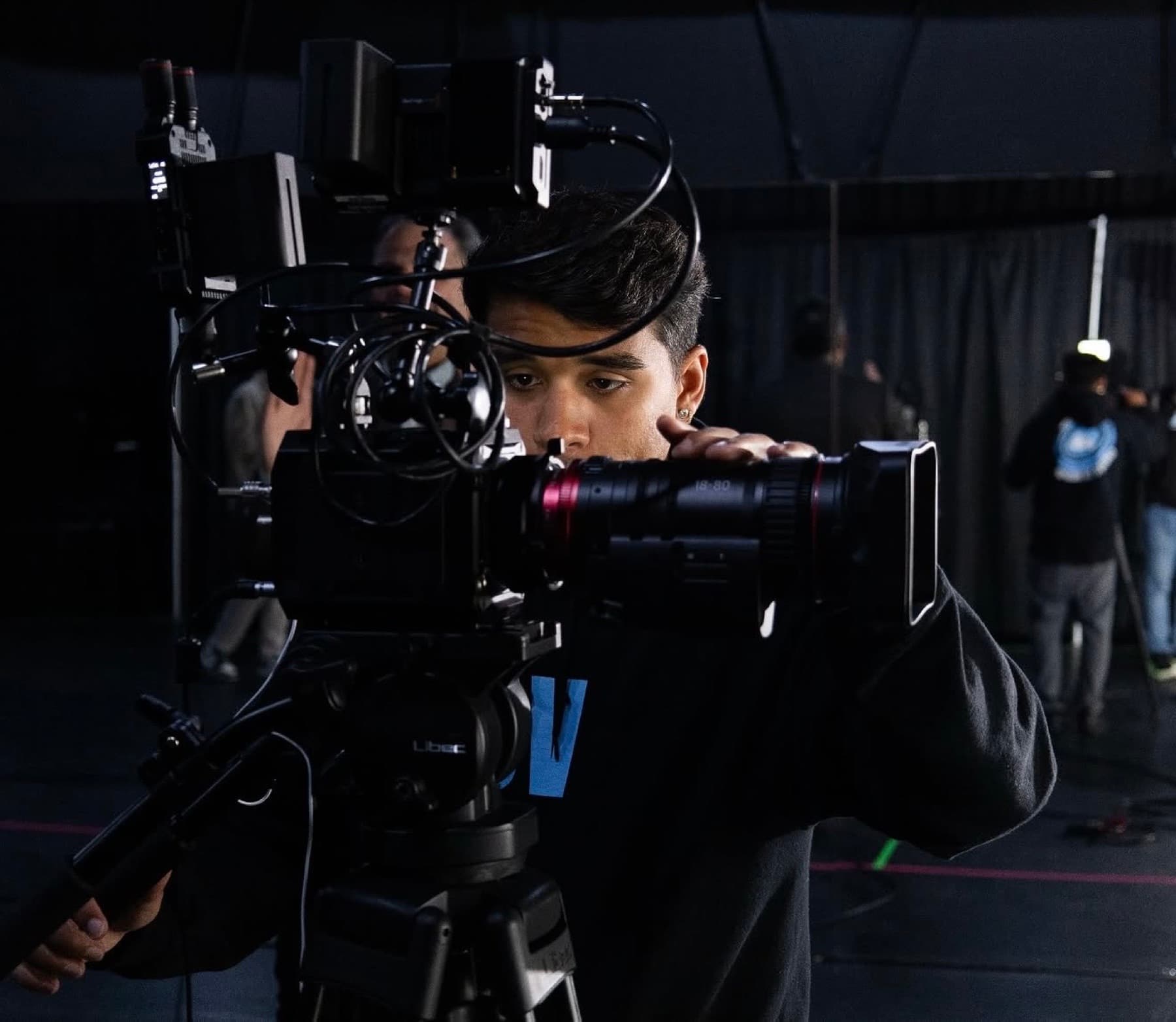 Camera operator preparing a cinema camera